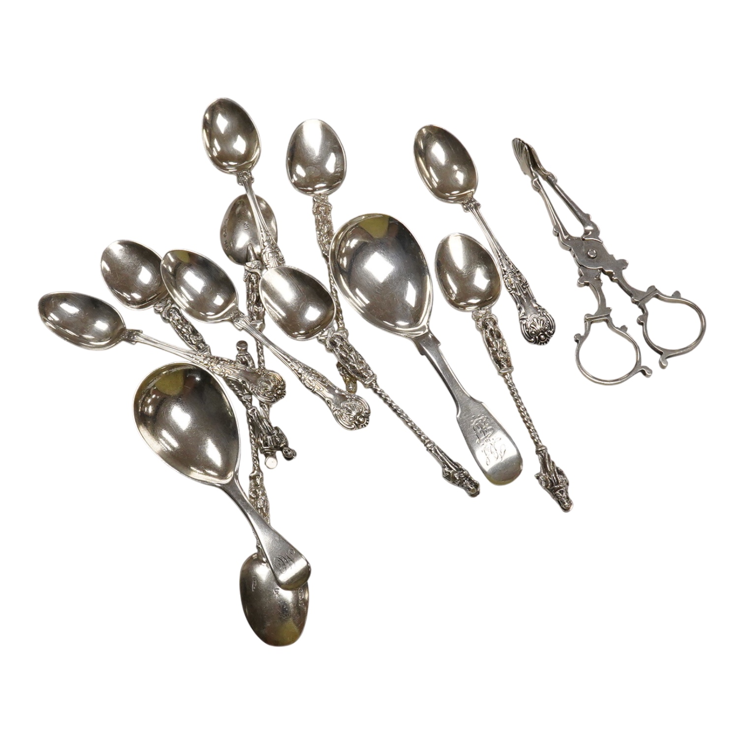 Two 19th century silver caddy spoons including Reid & Sons, Newcastle, 1837, ten assorted silver coffee spoons including apostle and a pair of George V silver sugar nips by William Hutton & Sons, 4.8oz.